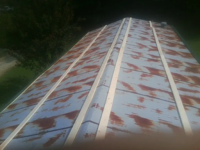 Rusted metal roof panels with new wood purlins before replacement — Storm Damage Roof Repair in Hurst by Roofing Brothers